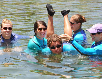 A group of students at ABC Animal Training bond by goofing around in the water